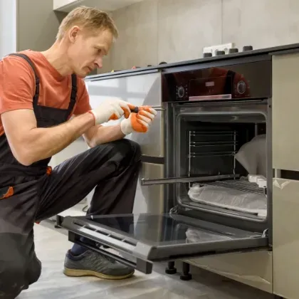 man servicing oven professionally